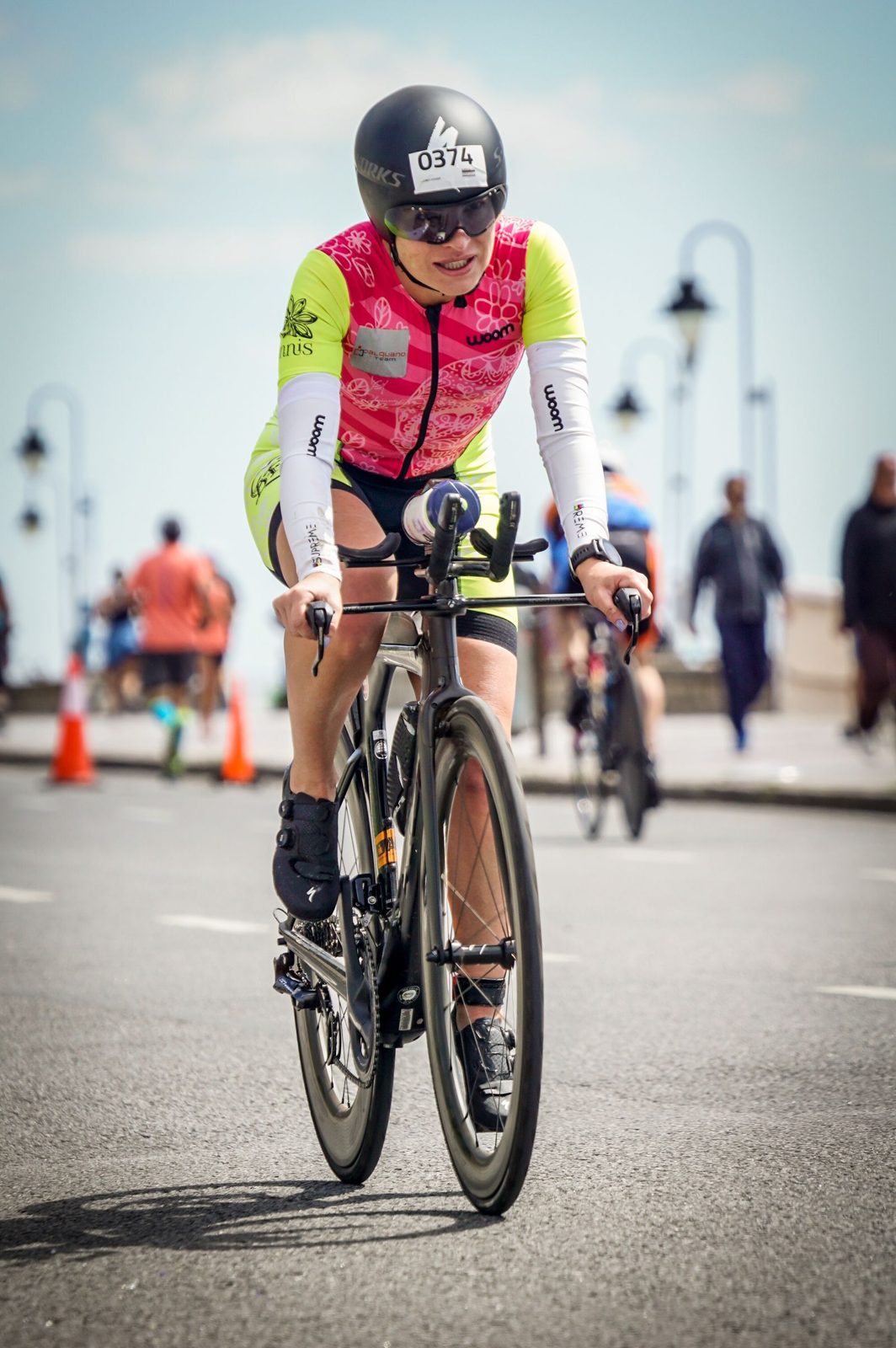 Triathlète en pleine section vélo lors d'une course, casque et position aérodynamique sous le soleil